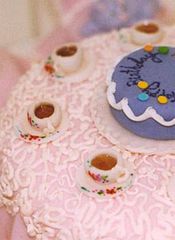 Detail of hand-painted miniature cups in sugar with sugar lace tablecloth