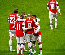 Arsenal players celebrating Lukas Podolski's goal against Coventry City