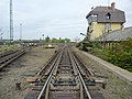 Image 22The "hump" of a hump yard. Railcars travel past retarders, which control their speed, and are directed onto tracks to be assembled into new trains. The control tower operates the retarders. (from Rail yard)