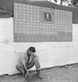 "Tired member of VF-17 pauses under the squadron scoreboard at Bougainville", February 1944