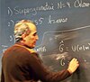 Edward Witten writing on a blackboard