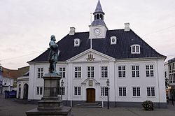 The old Town Hall on the square in Randers with a statue of Niels Ebbesen in the foreground.