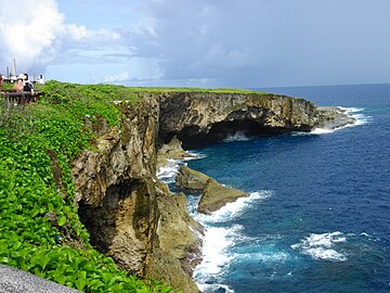 coastal cliff on left, ocean on right, cenotaphs in upper left corner