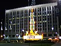 Nighttime photograph of a large building with a brightly lit marquee.