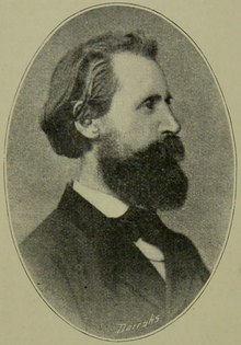 A vintage black-and-white profile photograph of a bearded man in formal attire, viewed from the side.