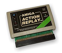 A rectangular software cartridge in a beige case with a black label and connector pins extruding from the bottom.