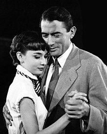 A black and white photograph of Peck with Audrey Hepburn in Roman Holiday.