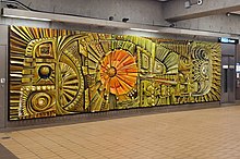 A large mosaic relief of colored fiberglass and other materials depicting abstract marine life