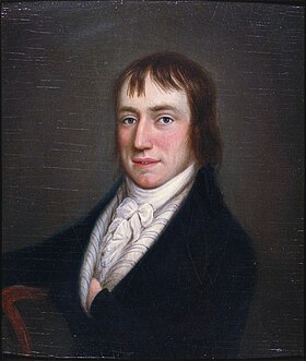 Half length portrait of a rosy-cheeked man in his late twenties, sitting in a black coat and white high-necked ruffled shirt with his left hand in his coat. He has medium-length brown hair.