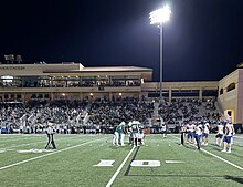 The Cal Poly football team's offense huddles in the red zone during a Big Sky Conference home win over Northern Colorado in 2023.