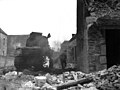 A member of the (A & S) Argyll & Sutherland Highlanders 4 Div. Run past a burning Canadian tank at St. Lambert on Dive