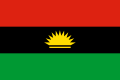 The flag of Biafra, a charged horizontal triband.