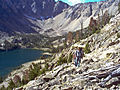 Hikers leaving Quiet Lake, which sits at the base of Castle Peak and Merriam Peak.