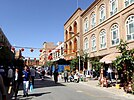 Street scene in a renovated part of Kashgar Old City. The renovated homes are reinforced with mud bricks and are of a reddish brown colour.