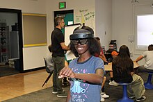 A student explores an environment using a VR headset.
