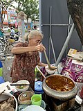 A lady preparing bún bò Huế at Dong Ba Market, Huế