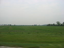 Broad farm fields in southwestern Rice Township
