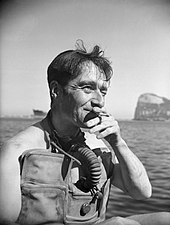photo of man wearing diving gear smoking