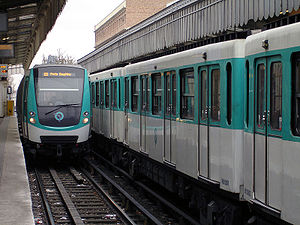 A MF 01 train passes a MF 67 at Jaurès