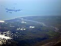 River mouth with Markarfljótsaurar flood plain and Vestmannaeyjar islands beyond. The snow cover is on the Eyjafjallajökull volcano.