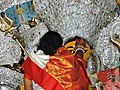 A woman dressed in garad sari devi baran (welcomes the goddess) on Bijoya Dashomi.