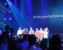 A group of people onstage, seen from the audience