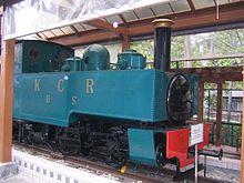 Blue-green locomotive in a museum