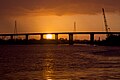 Sunset over the Cape Fear River flowing under the S. Thomas Rhodes Bridge.