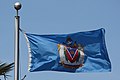 The flag flying outside Victoria's City Hall. This example incorrectly reverses the red and the blue in the shield of the coat of arms.