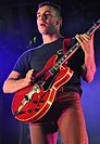 Man playing a red guitar