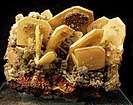 A classic cluster of butterscotch-colored wulfenite blades richly dusted with olive-green mimetite botryoids