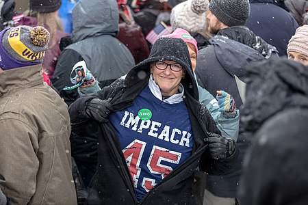 An Amy Klobuchar supporter wears an Impeach 45 t-shirt at Senator Klobuchar's rally to announce her 2020 presidential bid