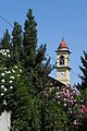 The bell tower of San Martino in Balsamo, behind the oleanders of the Pius XI Oratory
