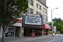 A brick building with a marquee listing upcoming performers