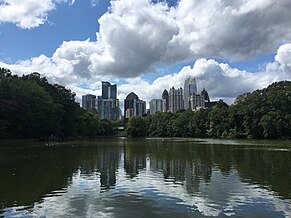 a lake with skyscrapers behind it