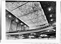 1932 image of auditorium ceiling and balcony soffit. Round holes in balcony edge are for stage lighting instruments. Dark windows in far wall are for film projectors and spotlights.
