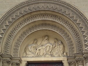 Tymanum of the central portal with sculpture of a Pieta by Joseph Tournois (1830–1891)