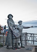 Statue of Annie Moore and her brothers on the quayside in Cobh, Ireland.