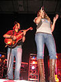 singer Colbie Caillat in knee length boots worn over jeans, 2008