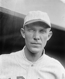 A man in a light, striped baseball jersey.