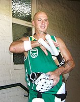 Picture of Gibbs wearing a South African training jersey and holding his bats and his gloves
