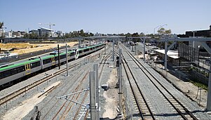 Six parallel tracks viewed from a bridge. The middle two tracks terminate and the outer two tracks on either side continue on.