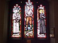 Stained glass west window depicting Óscar Romero, Pier Giorgio Frassati and André Bessette