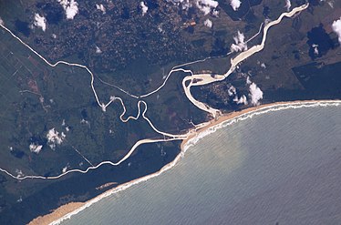 The old and new courses near the mouth, with the Msunduzi converging from the left (i.e. south), enclosing a wetland. Also note the silt plume at sea.