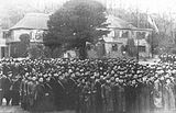 A photograph of HMS Europa. The sailors are waiting to be given their draft or ship by an officer.