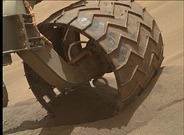 Wheel of the Curiosity rover partially submerged in sand at Hidden Valley (August 6, 2014)
