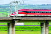 A Frecciarossa 1000 train at speed on a bridge in February 2021