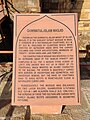 Plaque at the entrance providing visitors a background of Quwwat-ul-Islam Masjid