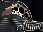 Sound holes precisely carved into the surface of a guitar can facilitate a desired sound.