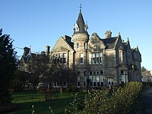 Scottish Baronial-style mansion house built of stone.